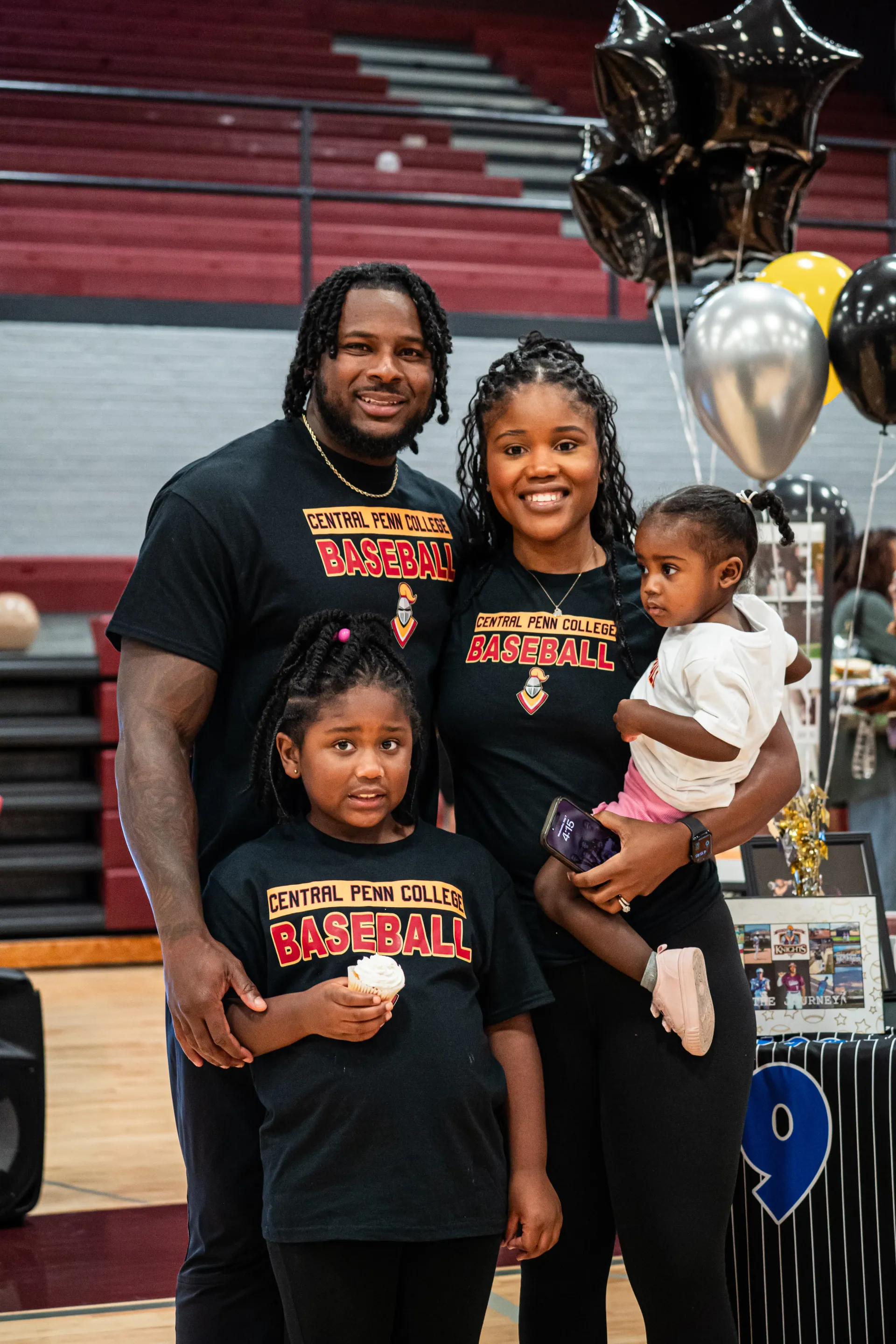 Coach Darnell Newman with his wife and children in matching Central Penn College Baseball shirts